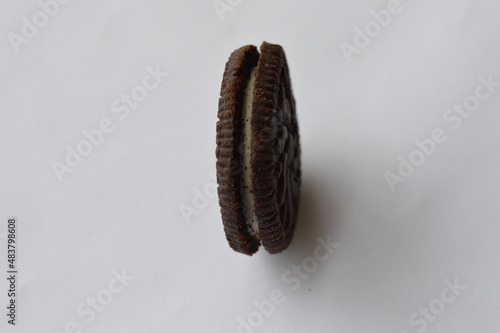 cocoa cookie with vanilla cream filling on a white background