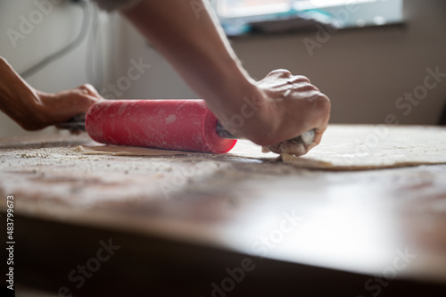 Rolling homemade pastry dough with a rolling pin