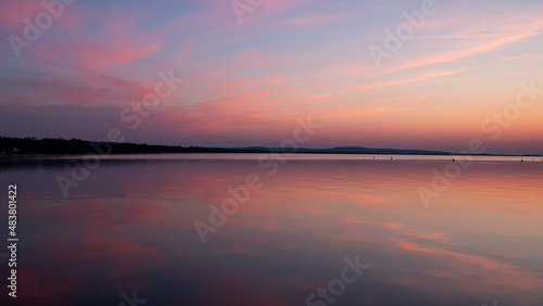 shortly after sunset at the Steinhuder Meer. The sky colored red. reflection on the water surface. Works well as a sky and as a texture