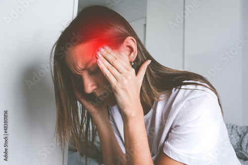 Canvastavla Young woman touching her temples and suffering from head pain, headache or migra