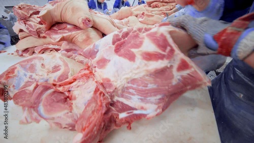 DONETSK, UKRAINE-DECEMBER 15,2018-Food industry, meat processing. Butchers cut pork at the meat processing plant in the cutting shop.