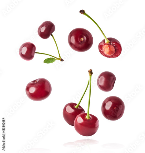 Fresh raw cheery falling in the air on white background.
