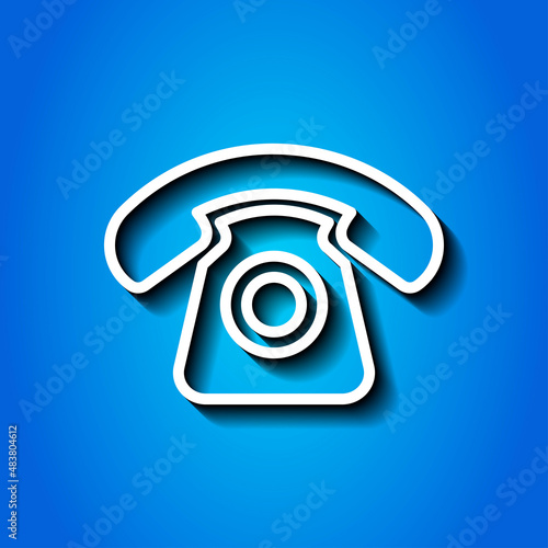 Old, retro phone simple icon. Flat desing. White icon with shadow on blue background.ai © Leo Kavalli
