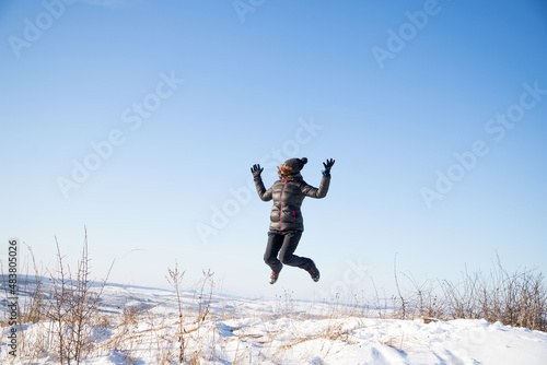 happy woman jumping outdoors in winter mindfulness © Melinda Nagy