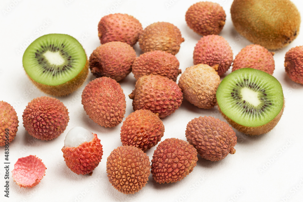 Two halves of kiwi and lychee on white Two halves of kiwi and lychee on white