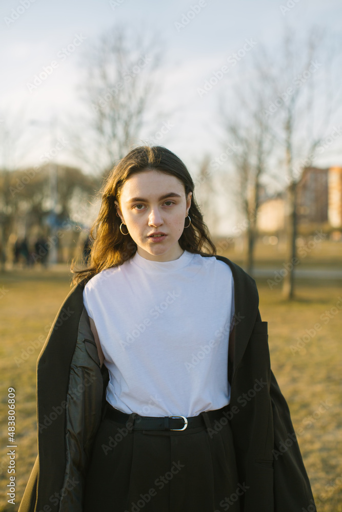 Portrait of a young fashionable woman outdoors in summer.
