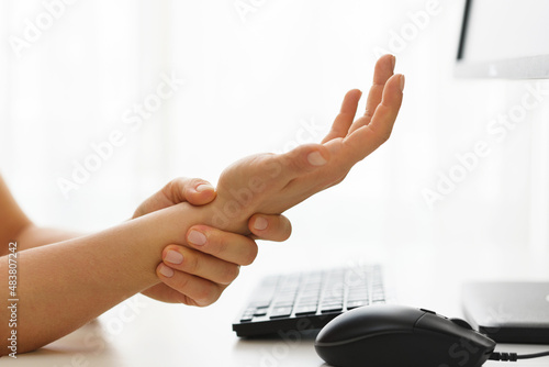 Female hands with a pain in the wrist because of carpal tunnel syndrome photo