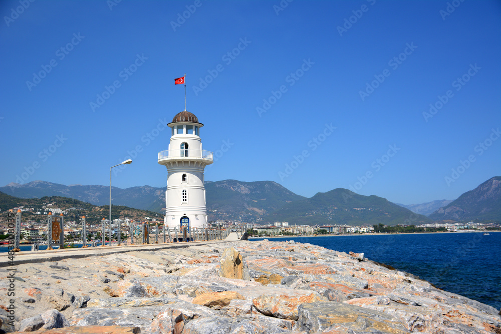 white lighthouse on mountains and blue sky background, Alanya Turkey
