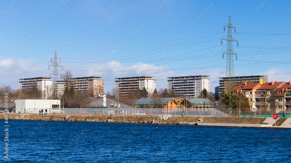 Fototapeta premium Power lines at the river Mur bringing electricity to Graz