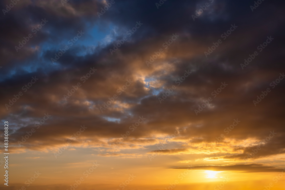 A beautiful, cloudy sunset sky with orange colors as texture or background