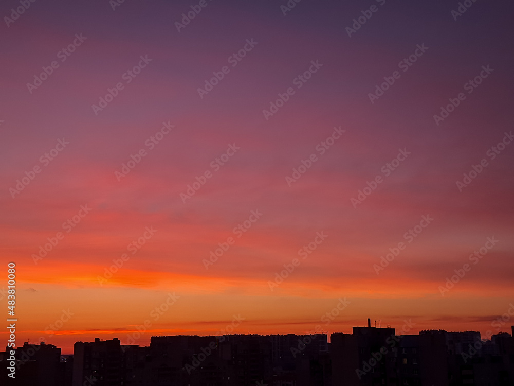 Sunset background with wonderful red,golden, yellow sky, Amazing purple and orange sky in evening during the sun going down above city.Dramatic sunset sky with clouds Sunset background with wonderful red,golden, yellow sky, Amazing purple and orange sky in evening during the sun going down above city.Dramatic sunset sky with clouds
