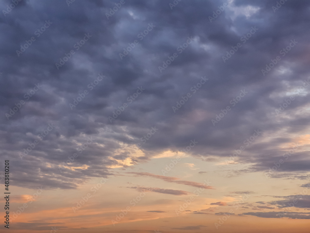 Obraz premium Sunset background with wonderful red,golden, yellow sky, Amazing purple and orange sky in evening during the sun going down above city.Dramatic sunset sky with clouds