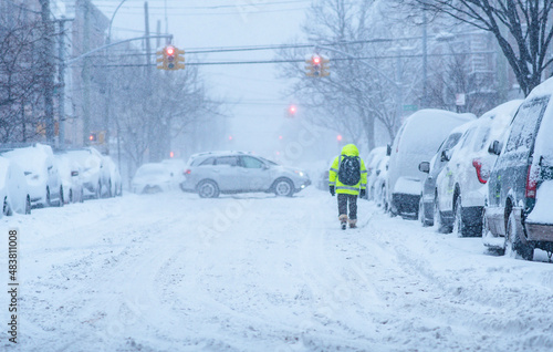 City bad weather, snow storm in city streets, cars covered by snow, heavy snow fall. photo