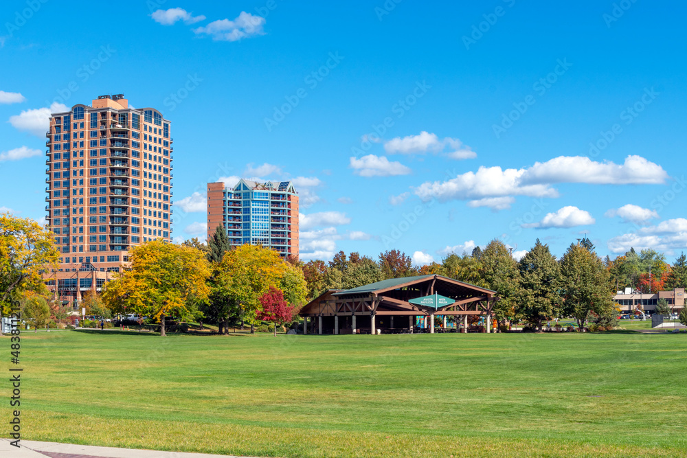 The public McEuen Park, pavilion and apartment buildings in the downtown area of the rural lakefront city of Coeur d'Alene, Idaho, USA.