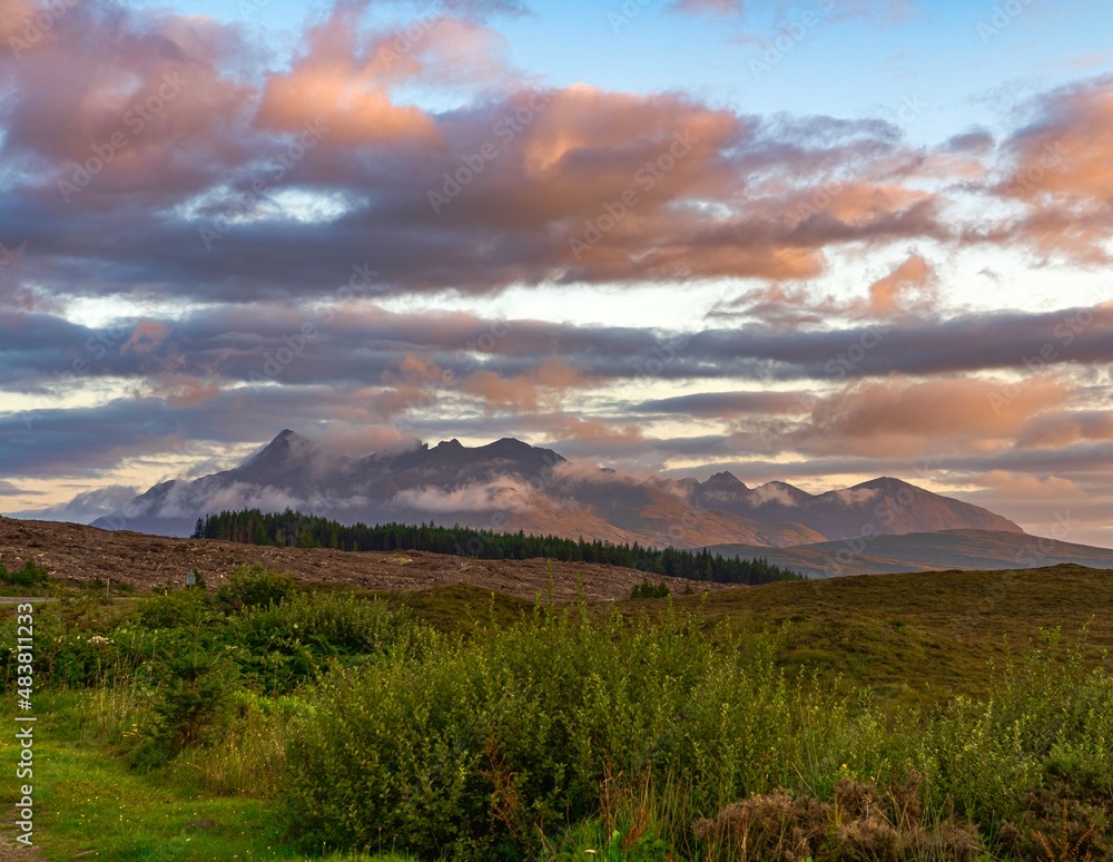 Isle of Sky Scotland highlands sunset with nice colours on the mountains in background and beautiful clouds 