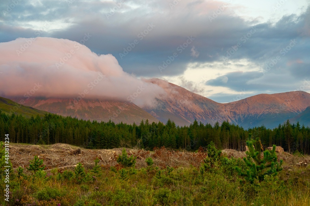 Fototapeta premium Sunset with beautiful colours on mountains and clouds in background 