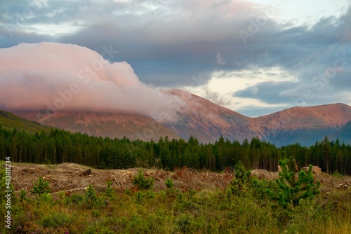 Sunset with beautiful colours on mountains and clouds in background 