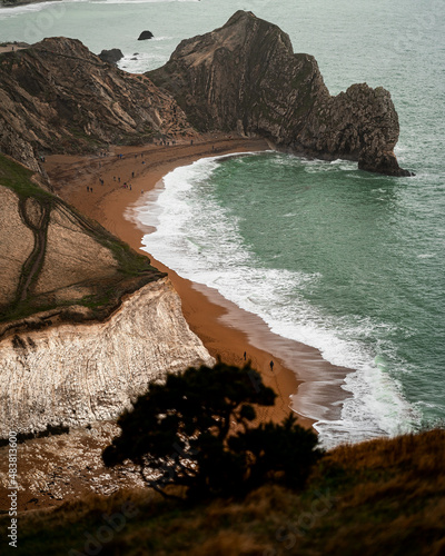 Durdle Door Beach in cold misty day with strong sea waves 