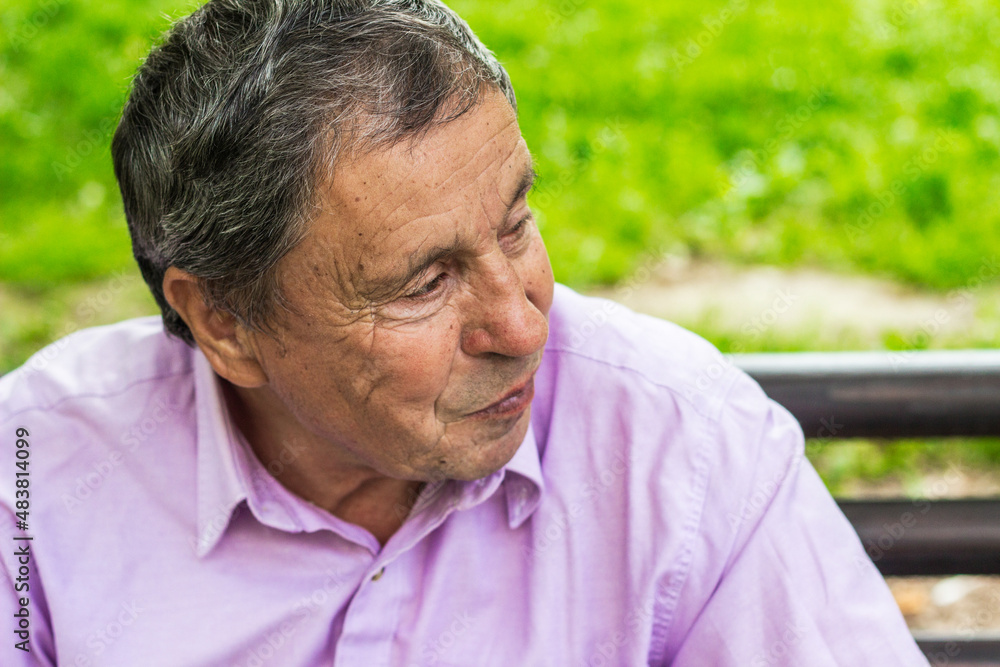 Senior man sitting on bench in the park Senior man sitting on bench in the park