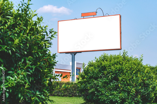 Blank billboard mockup with white screen. Against the backdrop of nature and blue sky. Business concept. Copy space banner for advertising.