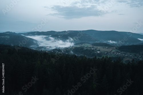 Czech typical autumn landscape with rock infront of capture. Hills and forest with foggy morning. Morning fall valley of Podkrkonosi, wild Europe.