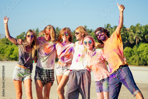 multinational multicultural mixed race friends in holi dust on beach in Goa