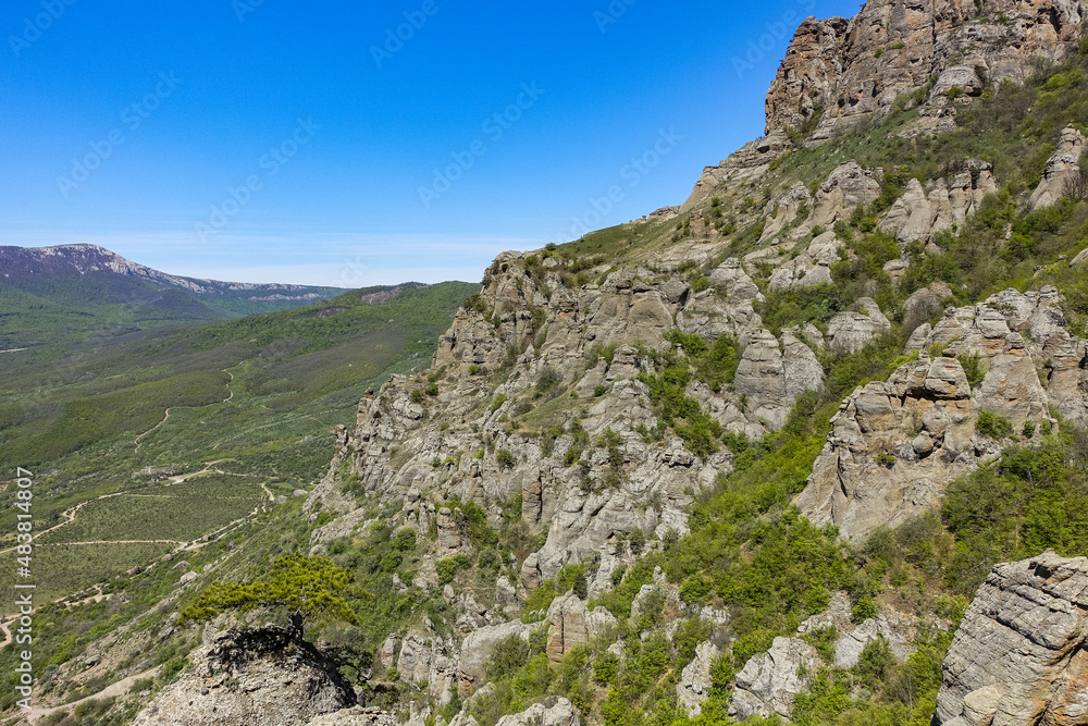 The Valley of Ghosts. Demerji. Green trees and bushes in the foreground. May 2021. Crimea.