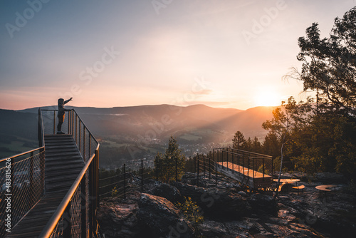Man pointing straigt on a wonderful sunrise on new and modern lookout forest park The Guard Patrol, Czech: Straz, Sunrise on Straznik Hill above Rokytnice nad Jizerou, Giant Mountains National Park
