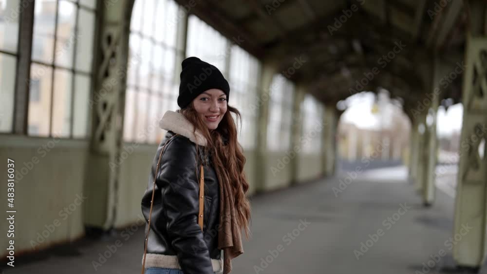 charming teen girl is wearing casual street style for winter season is walking in suburban station charming teen girl is wearing casual street style for winter season is walking in suburban station