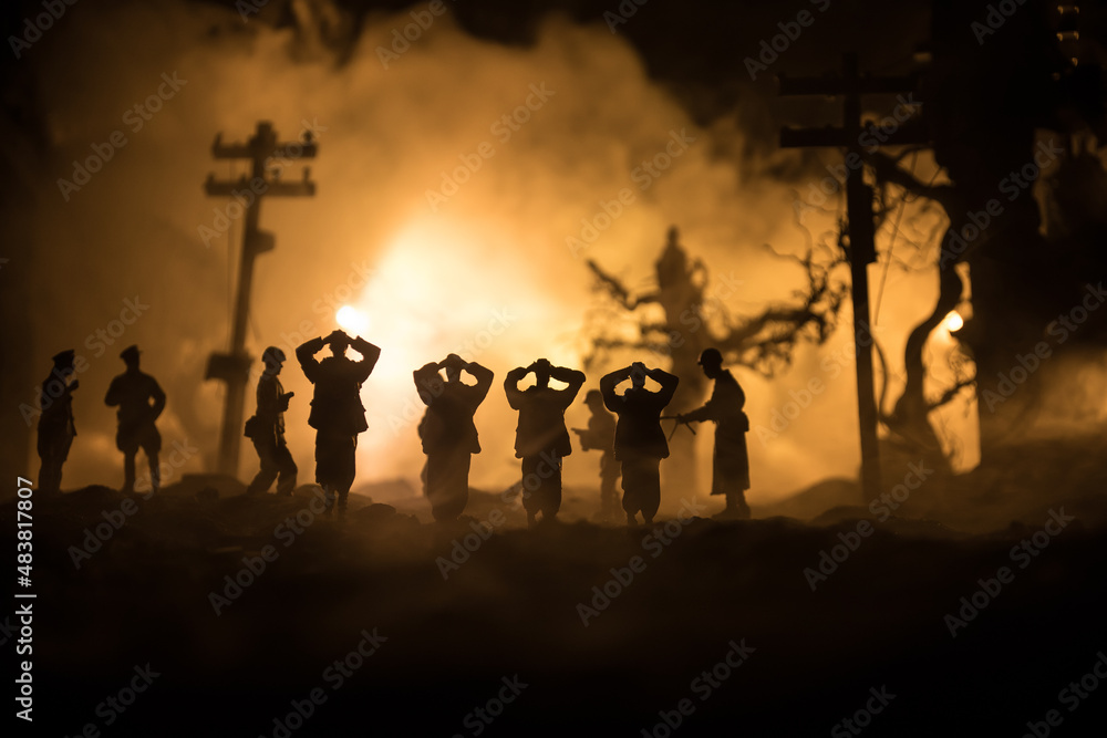 Battle scene. Military silhouettes fighting scene on war fog sky background. A German soldiers raised arms to surrender. Plastic toy soldiers with guns taking prisoner the enemy soldier. Artwork Battle scene. Military silhouettes fighting scene on war fog sky background. A German soldiers raised arms to surrender. Plastic toy soldiers with guns taking prisoner the enemy soldier. Artwork
