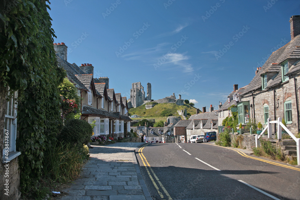 The castle in the distance, from East Street, Corfe Castle, Isle of Purbeck, Dorset, UK