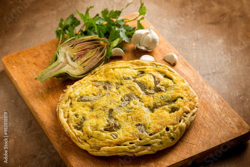 wole omelet with artichoke with parsley and garlic photo
