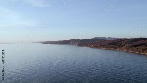 Wallpaper Mural The Black Sea coast during sunset in December. Loose buildings on the shore: hotels and individual buildings on the background of hills. Several piers and small loading cranes. Torontodigital.ca