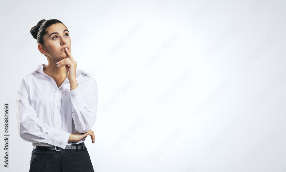 Thinking concept with pensive girl in white shirt on abstract white background with place for your text or logo, mockup Thinking concept with pensive girl in white shirt on abstract white background with place for your text or logo, mockup