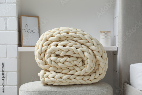 Tableau sur toile Soft chunky knit blanket on ottoman indoors