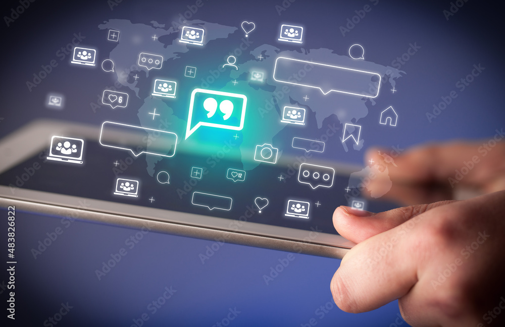 Naklejka premium Close-up of a hand using tablet, social media concept