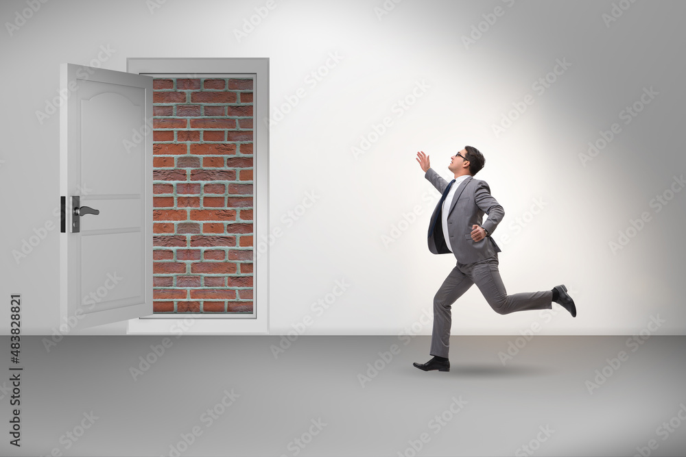 Fototapeta premium Businessman facing no exit with brick door