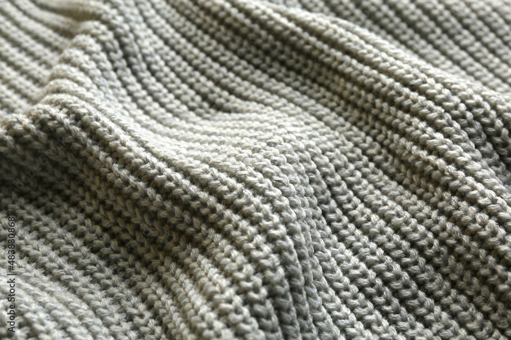 Beautiful grey knitted fabric as background, closeup Beautiful grey knitted fabric as background, closeup