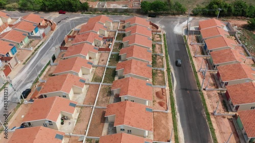 Aerial view of community houses in construction. Panoramic view of popular housing. Suburb popular houses. Community housing construction. Condominium suburban popular neightborhood houses.  photo