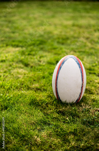 Rugby  ball , Gilbert ,on sports field with green grass for the game of rugby. Focus on ball, sports base at background.oval,rugby team,try,rugby ball,grass,ball,rugby,team sport,sport,team sports,six