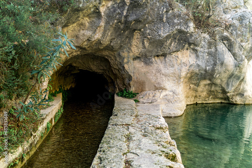 concrete artificial rill under the rock in a mountainous area