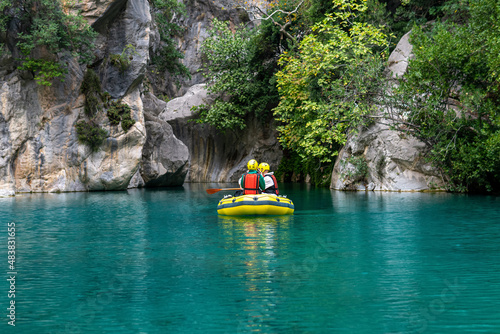 tourists on an inflatable boat rafting down the blue water canyon in Goynuk, Turkey