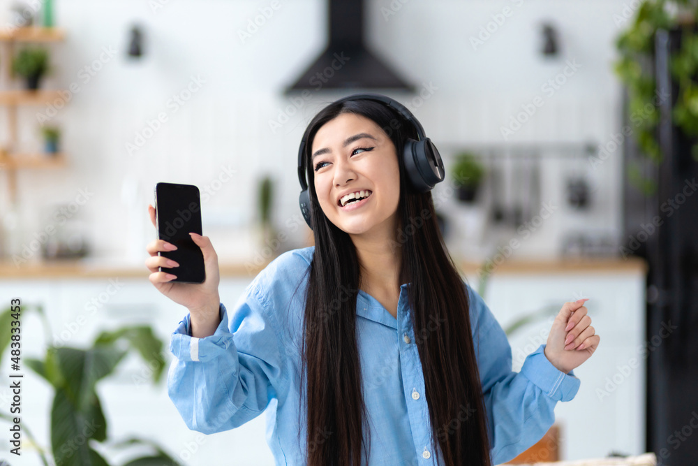 Happy carefree woman joyfully dancing fun home