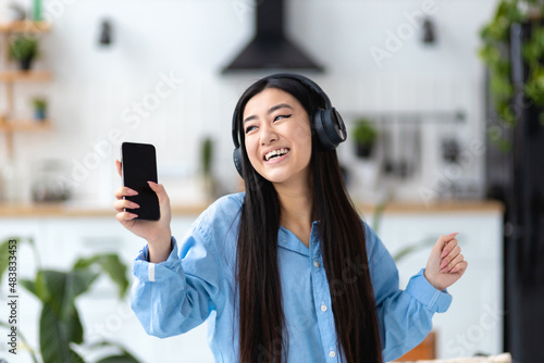 Happy carefree woman joyfully dancing fun home