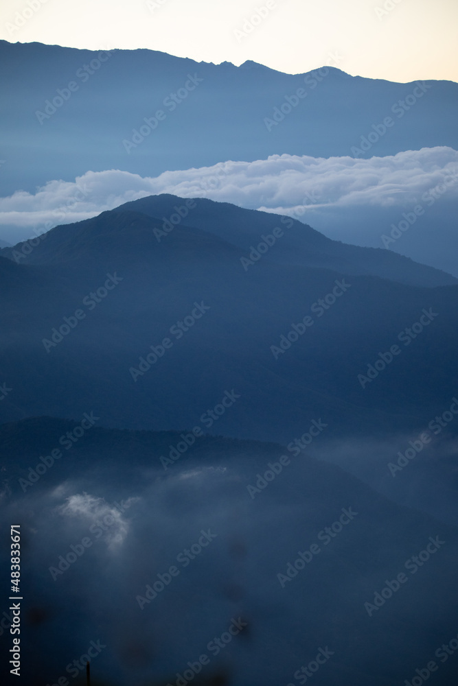 Blue beautiful mountains Ands in Colombia Latin America with clouds and fogs in the early morning, landscape