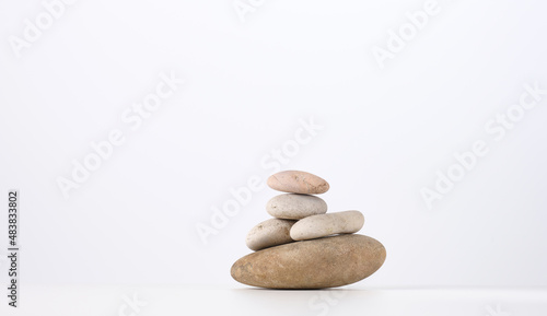 stack of round stones on a white background. Scene for demonstration of cosmetic products