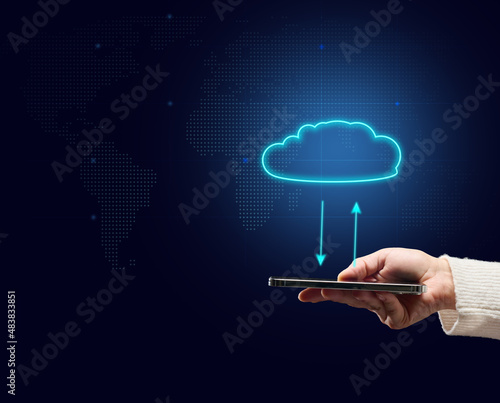 female hand holding mobile phone and virtual cloud. Sharing information, backing up, downloading and updating applications