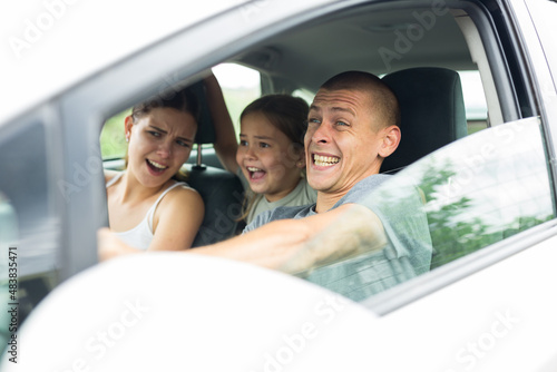 Man driver, his wife and doughter scared screaming in the car before the road traffic accident © JackF