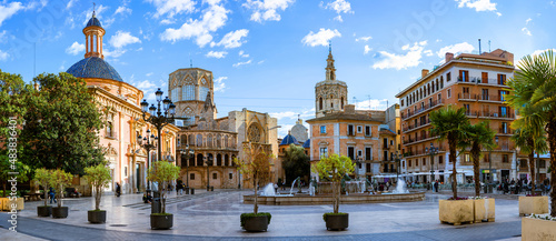 Evening panoramic view of Square of Saint Mary or Virgens square with Valencia Cathedral Temple, Basilica de la nuestra senora de los desamparados and the rio tura fountain in old town Valencia Spain photo