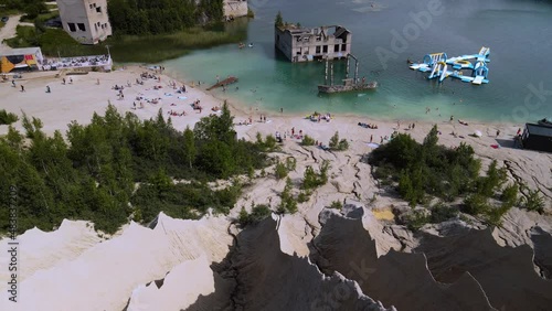 FPV expierence flying down a sand dune formation. View on abandoned underwater prison.  photo